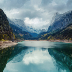 alpine lake with dramatic sky and mountains. tirol, austria