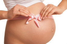 Pregnant Woman Tummy With Pink Ribbon Over White