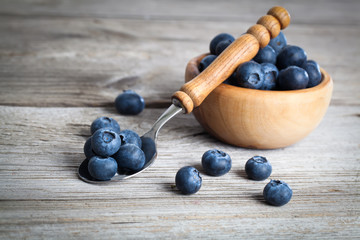 Wall Mural - bowl of blueberries on wooden background