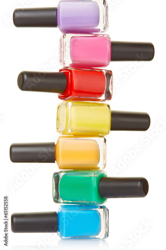 Nail polish bottles colorful stack on white, clipping path Poster