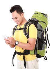 Poster - portrait of a smiling male hiker with backpack using mobile phon