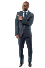 Happy businessman pointing at something