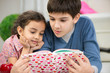 © spass - Two children reading book at home