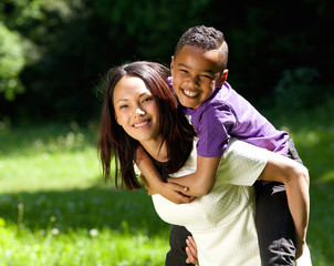 Wall Mural - Mother and son smiling together outdoors