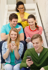 Sticker - smiling students with smartphone texting at school