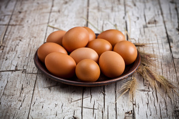 fresh brown eggs in plate