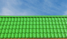 View Of Green Roof Tiles And Sky On The Background.