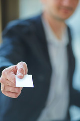 Man's hand showing business card