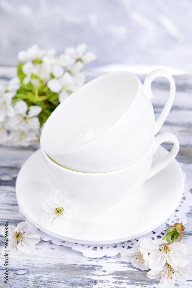 Beautiful fruit blossom in glass on table on grey background