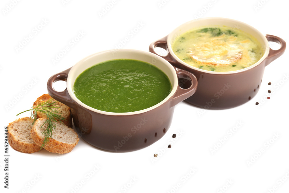 Tasty soup in saucepans, isolated on white
