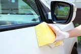 Fototapeta Przestrzenne - Outdoor car wash with yellow sponge
