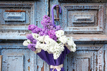 Beautiful Lilac Flowers In Umbrella On Old Wooden Doors