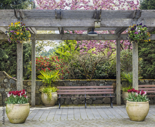 Naklejka na szybę Rustic pergola with bench and flower pots