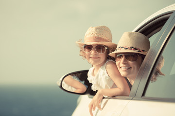 Happy woman and child in car