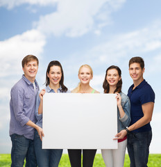 Canvas Print - group of standing students with blank white board