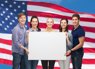 group of standing students with blank white board