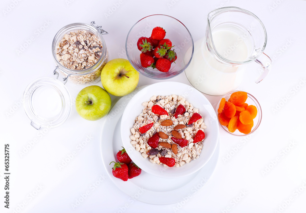 Healthy cereal with milk and fruits isolated on white
