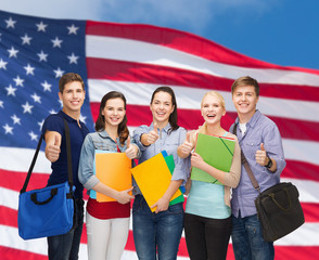Wall Mural - group of smiling students showing thumbs up