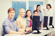© Syda Productions - students with computer monitor at school