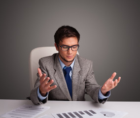 Wall Mural - Businessman sitting at desk and doing paperwork