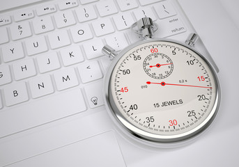 Sports stopwatch lying on a computer keyboard