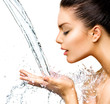 Beautiful woman with splashes of water in her hands