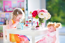 Toddler Girl Playing Tea Party With A Doll
