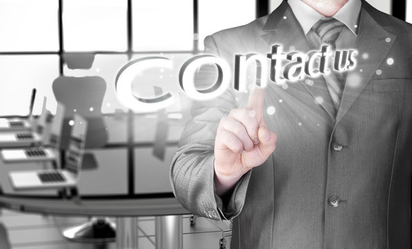 Businessman pushing CONTACT US sign