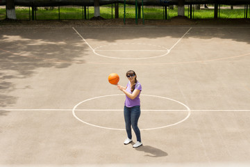 Wall Mural - Middle aged woman playing a game of basketball