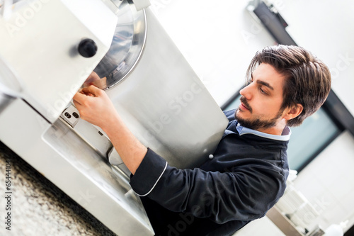Fotografie, Obraz Commercial cook or chef slicing cold meat