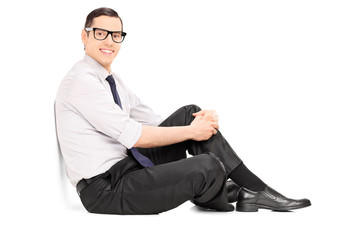 Canvas Print - Fashionable young man sitting on the floor