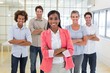© WavebreakmediaMicro - Businesswoman and coworkers smiling at camera