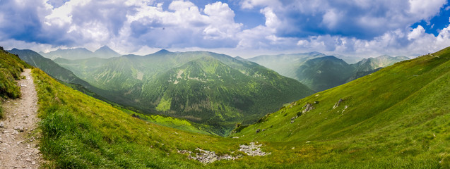 Wall Mural - panoramic view of mountain peaks from the trail