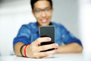 Sticker - Closeup portrait of a man using smartphone. Focus on smartphone.