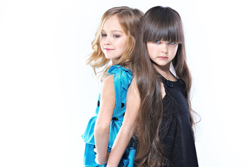 Canvas Print - portrait of two beautiful young girlfriends in studio