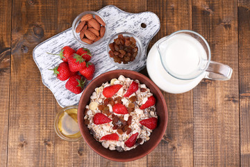 Canvas Print - Healthy cereal with milk and strawberry on wooden table