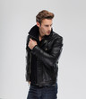 © mast3r - Fashion man, model leather jacket, gray background