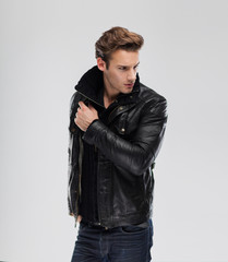 Fashion man, model leather jacket, gray background