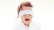 © ASTA Concept - Portrait of attractive woman blindfolded with white paper ribbon