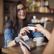 © gpointstudio - Happy woman paying for cafe by credit card