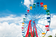 Giant Ferris Wheel Against Blue Sky And White Cloud