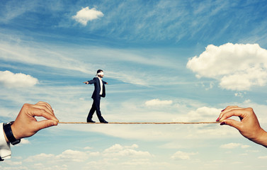 Canvas Print - man with closed eyes balancing on the rope