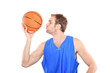Young sportsman kissing a basketball