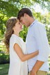 © WavebreakmediaMicro - Cute couple hugging and smiling in the park