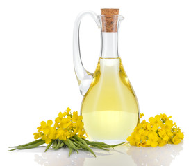 Rapeseed oil and flowers isolated over white.