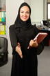 Arabic woman, greeting a person inside office.
