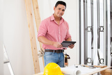 Happy Contractor Using A Tablet