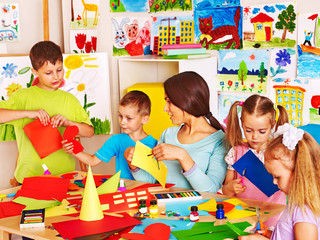 Children with teacher at classroom.