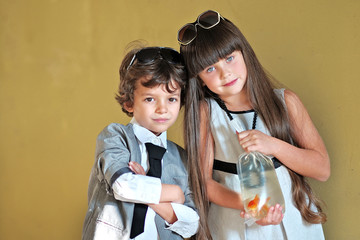 Wall Mural - Portrait of a girl and boy with a goldfish