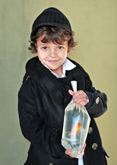 Wall Mural - Portrait of a boy with a goldfish